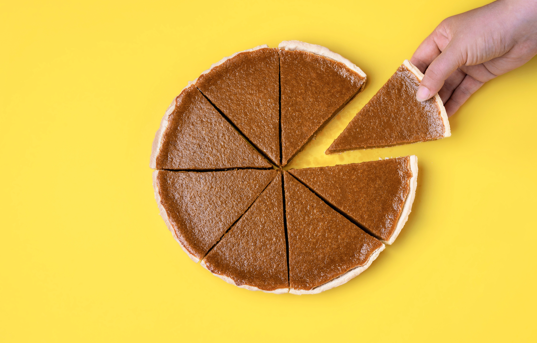 Sliced pumpkin pie. Taking a pie slice.